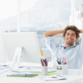 Relaxed casual business man with computer in bright office