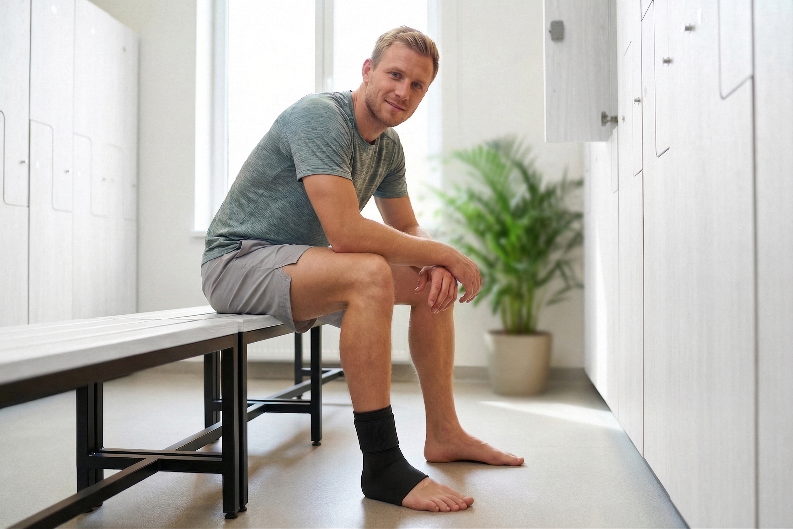 A man in a locker room wearing a medisana ankle gel pack